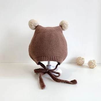 Cuddle Up with Cozy Style: Šiltos rudens ir žiemos kūdikių ausų sklendės su žavingais pompominiais akcentais (3-18 mėnesių)